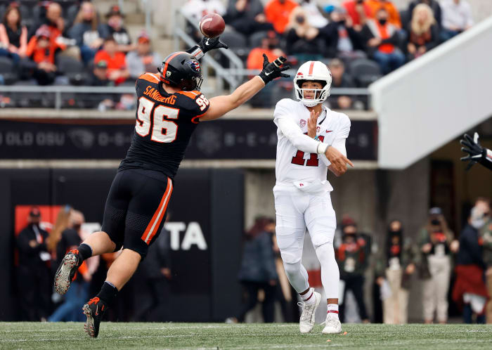 Nov 13, 2021; Corvallis, Oregon, USA; Stanford Cardinal quarterback Ari Patu (11) throws under pressure from Oregon State Beavers defensive lineman Simon Sandberg (96) during the first half at Reser Stadium. Mandatory Credit: Soobum Im-USA TODAY Sports